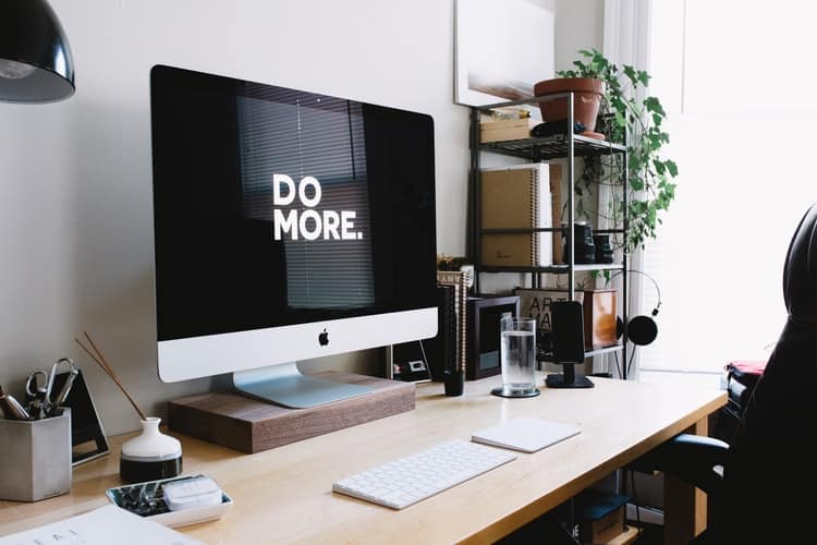 A work desk with a large computer.