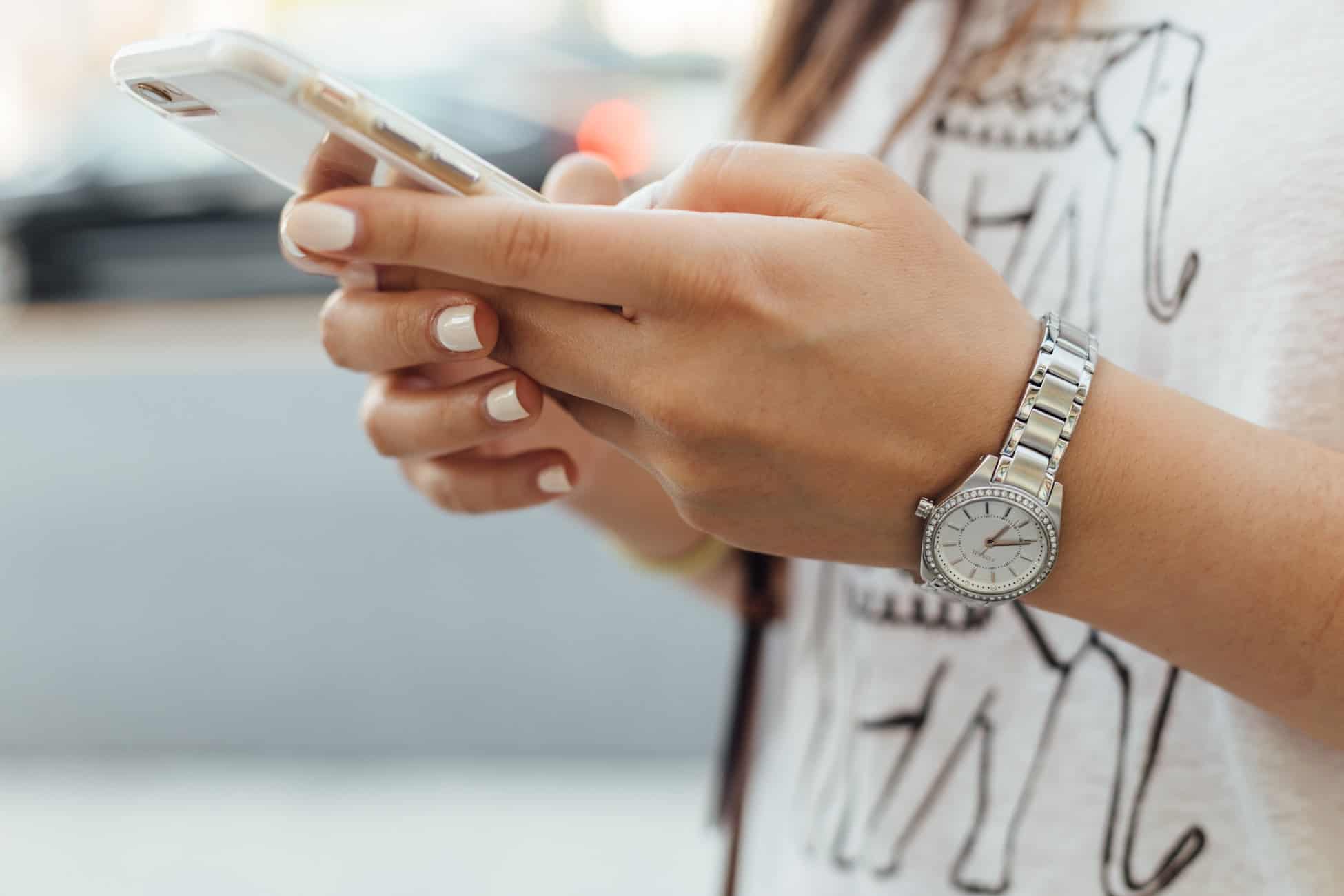 Person using their phone. Caption: With at least half of your traffic coming from mobile users, optimizing for them is very important.