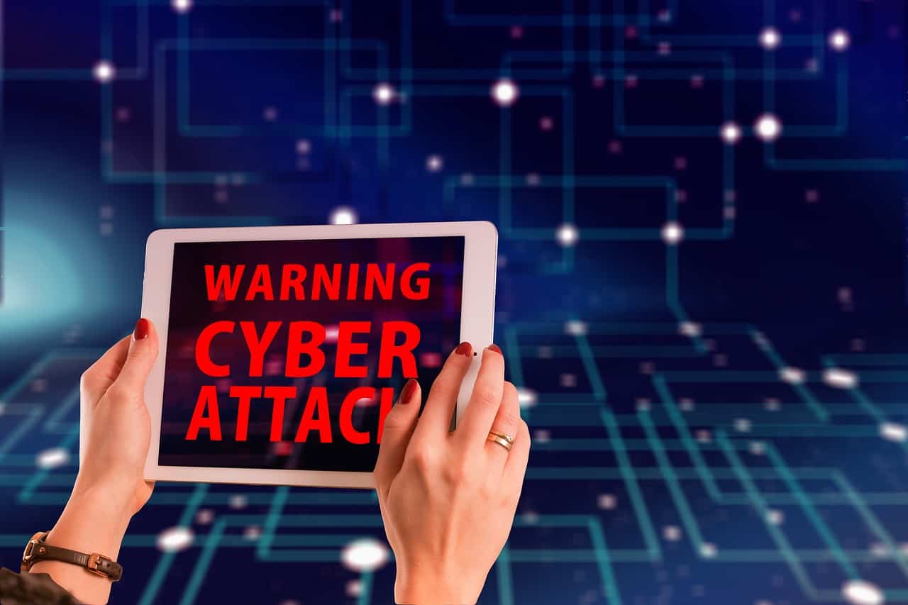 Warning about cyber attacks and different types of negative SEO on a tablet.
