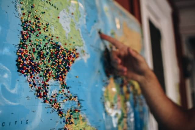 A person choosing target locations on a world map before designing a globalized website.