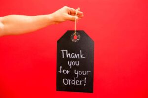 a person holding a thank you signage.